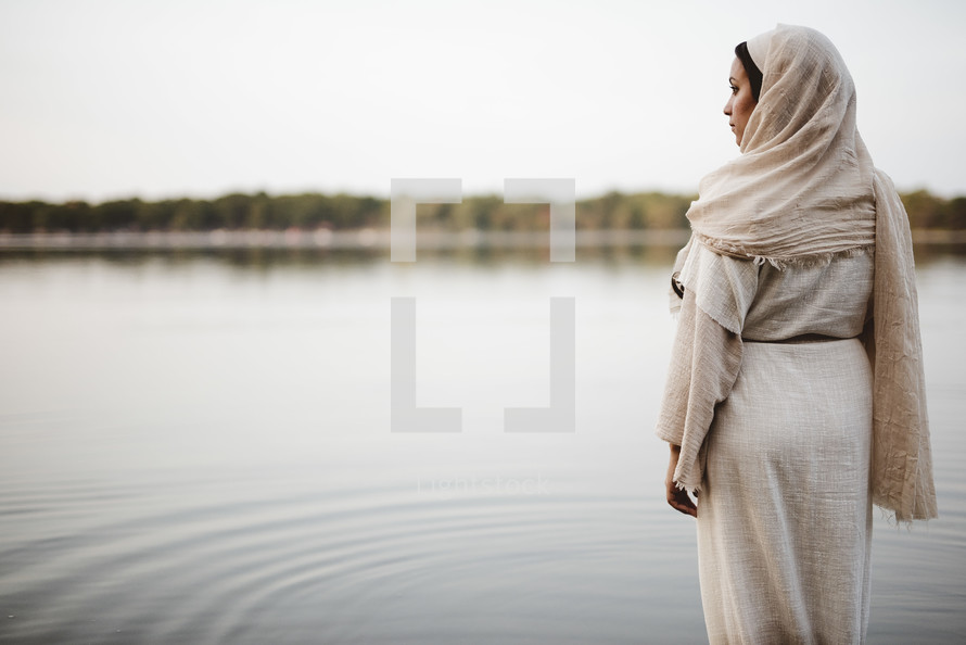 woman in biblical times standing near water 