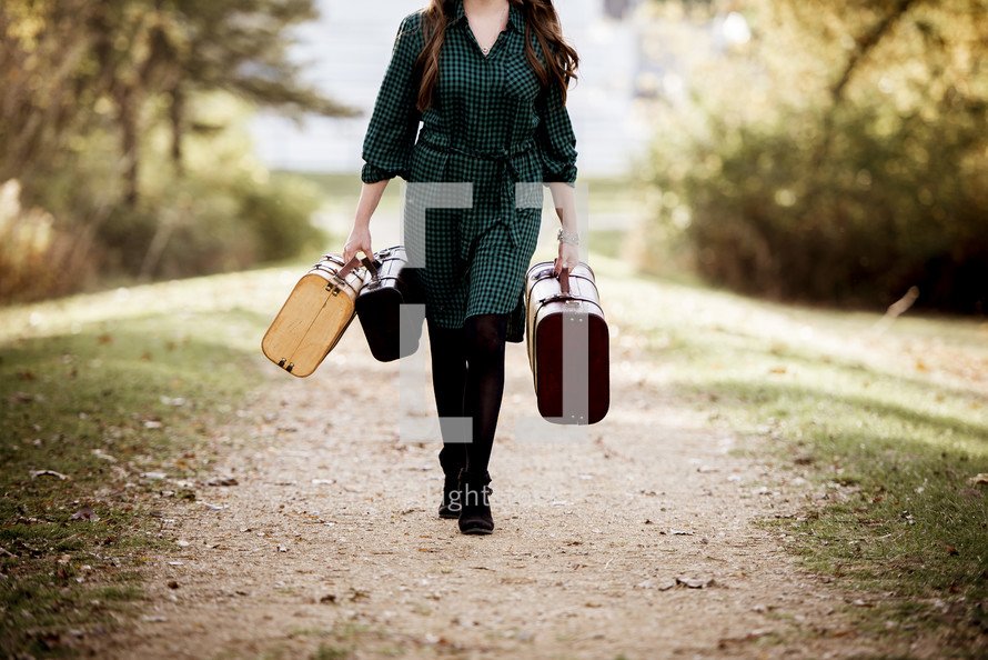 a woman walking carrying luggage