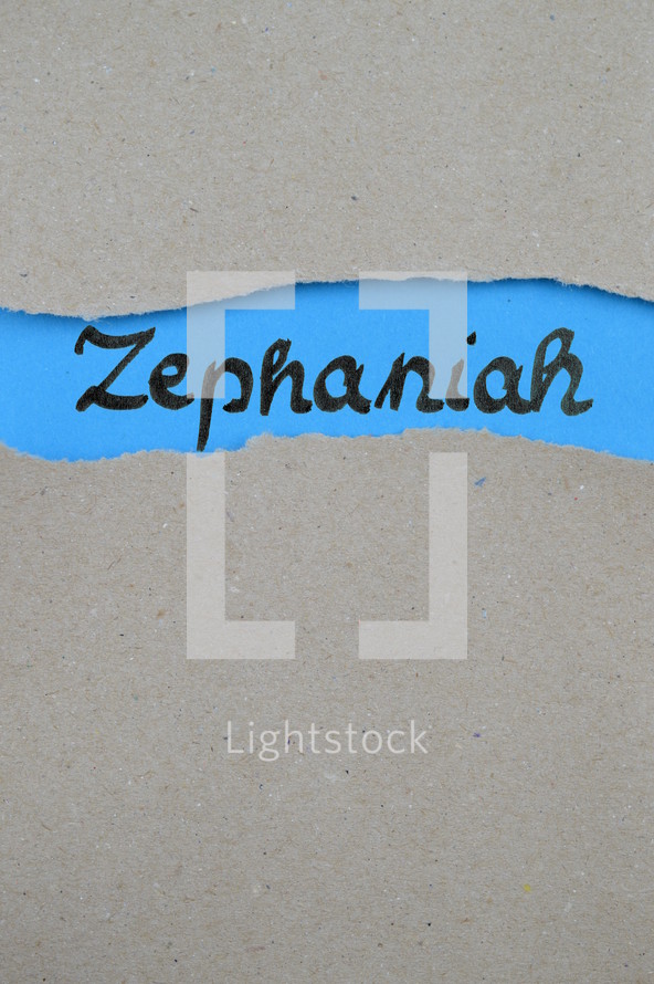 Zephaniah - torn open kraft paper over blue paper with the name of the prophetic book Zephaniah