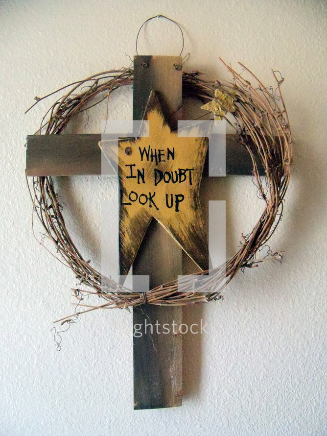 The Symbol of the Old Rugged Cross, with the words "When in Doubt Look up" symbolic words of encouragement on a wooden cross to provide hope, faith, encouragement when times are difficult as they often are. 