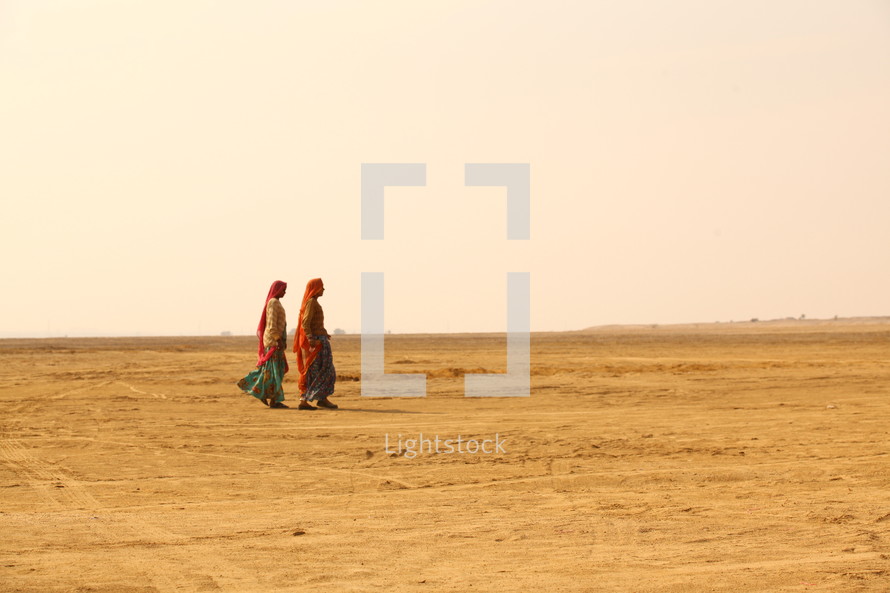women walking in the desert 
