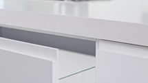 Close up of a white modern luxury kitchen drawer closing slowly
