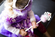 a toddler girl dressed up like a princess 