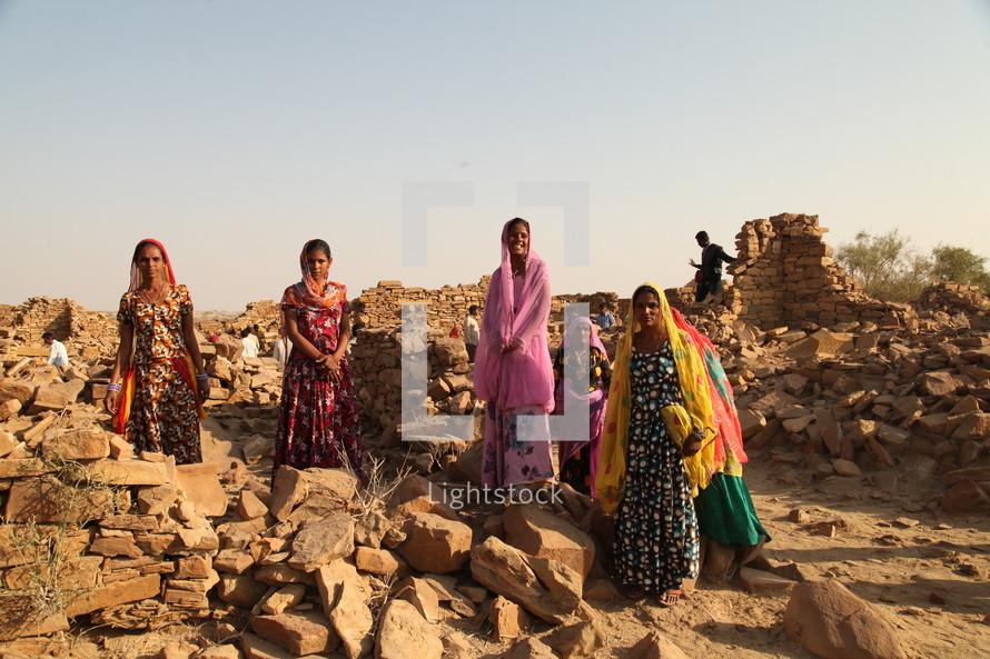ruins, stacked, piles, stones, rocks, crumbling, walls, women, India, traditional clothing, head scarves 
