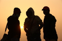 silhouette of men standing in a desert 