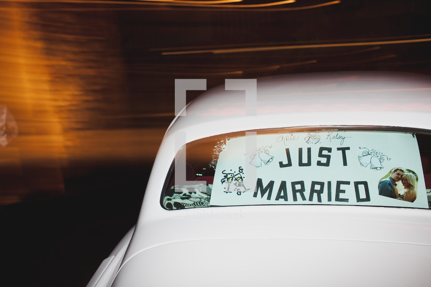 "Just Married" sign in back car window
