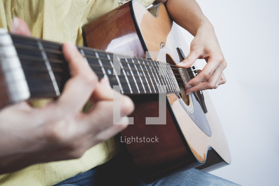 man playing a ukulele 
