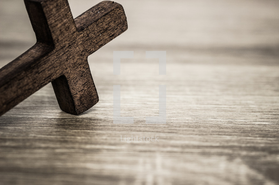 wood cross on a wood background 