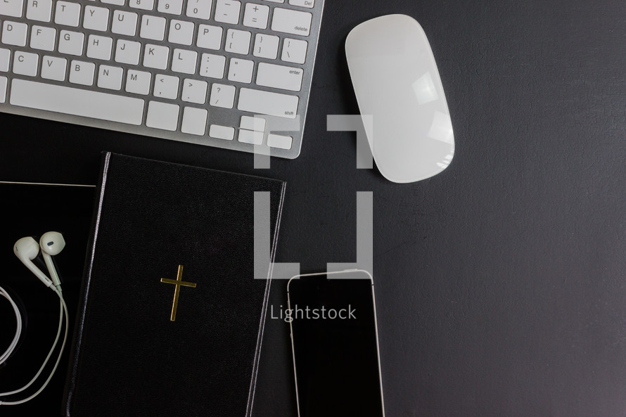 computer desk with Bible and smartphone 
