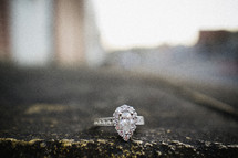 engagement ring on asphalt