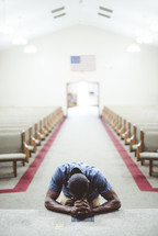 a man kneeling in prayer at an altar 