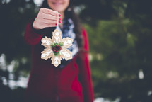 girl holding a Christmas ornament 