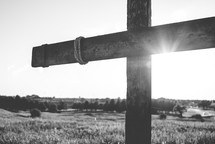 a wooden cross in a field 
