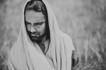 Jesus thinking alone in a field