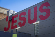 word Jesus painting on the side of a building 