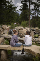 young women discussing scripture outdoors 