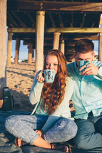 a couple on their honeymoon on a beach having a picnic 