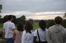teens looking out at a green pasture 