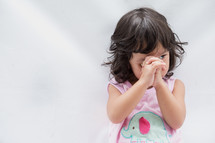 a toddler girl praying 