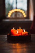 red candles and bokeh lights at Christmas 