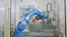 Robotic line at a manufacturing facility. Robot placing metal parts