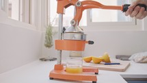 Super slow motion of fresh orange juice squeezed using a manual squeezer