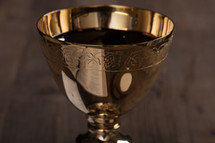 A golden communion goblet and communion wine.