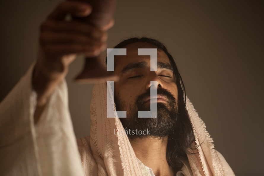 Jesus with a raised communion chalice 