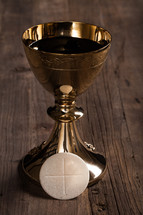 A goblet of communion wine and a communion wafer.