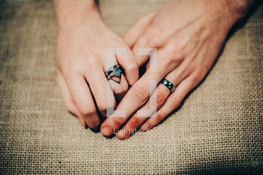 bride and groom's hands with wedding bands 