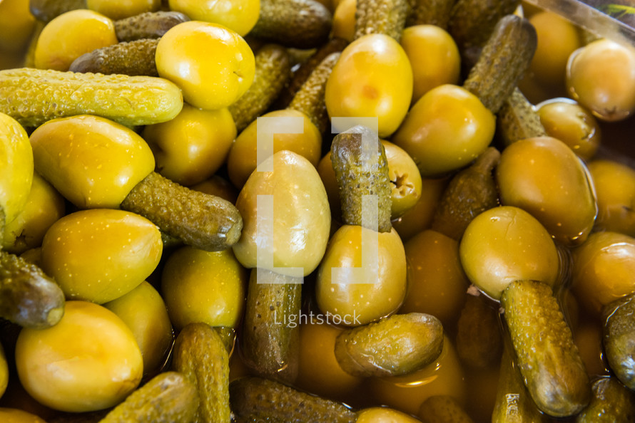 Close up green olives stuffed with baby gherkins