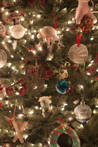 closeup of ornaments on a decorated Christmas tree 