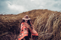  portrait of woman in a field of tall brown grasses 