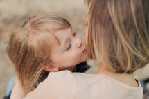 daughter kissing her mother 