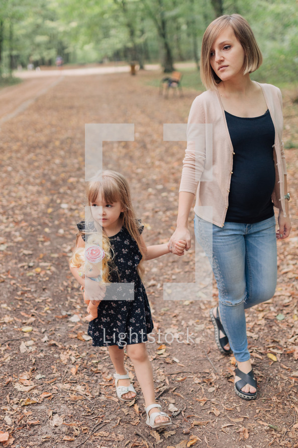 mother and daughter walking holding hands 