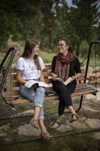 teen girls sitting outdoors reading Bibles 