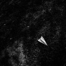 paper airplane in grass
