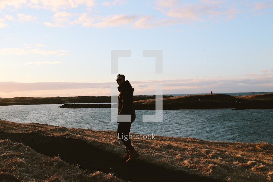 a man walking on a shore in Iceland 