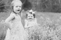 Two small children in a field of flowers.
