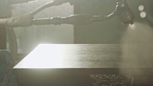 Slow motion of a worker painting kitchen wood doors using spray paint
