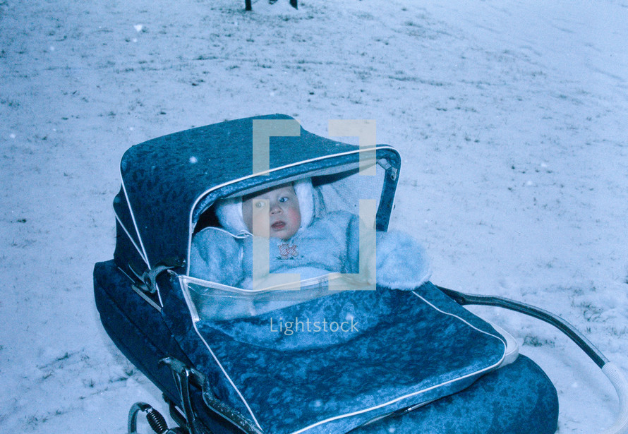 vintage image of a baby in a baby buggy 