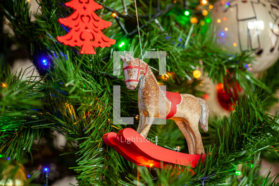 Rocking horse Christmas ornament hanging on a tree