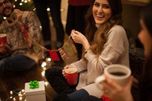 people drinking hot cocoa and talking at a Christmas party 