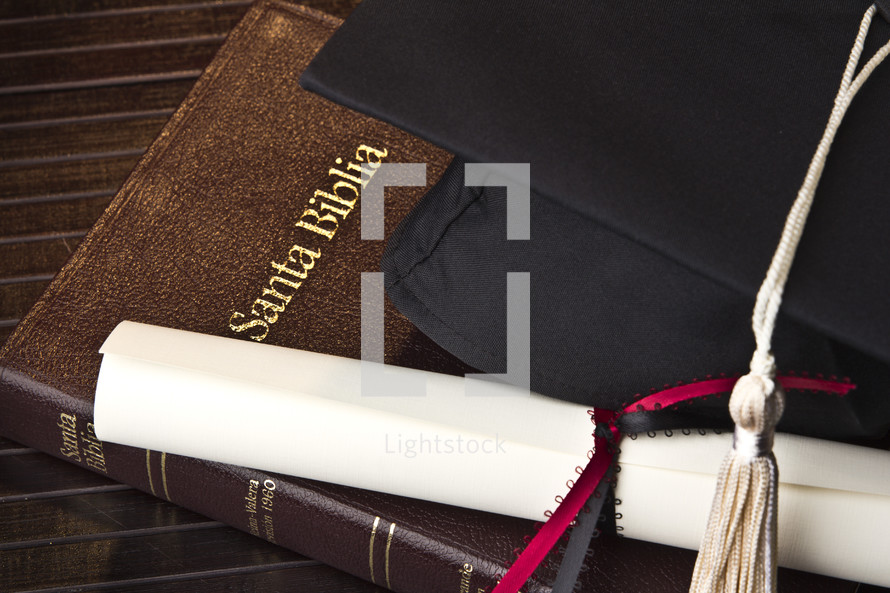 Spanish Bible, diploma, cap, tassel