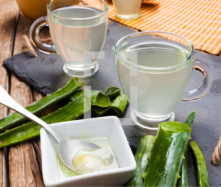 Drink aloe vera and honey. Glass cups on a slate tray