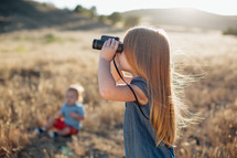 a child with binoculars 