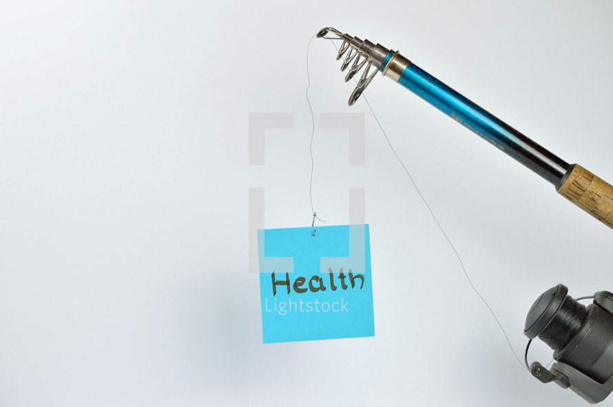 the word health on a cyan piece of paper hanging from a fishing line 
