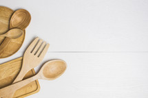 wooden spoons, and cutting boards on a white background 