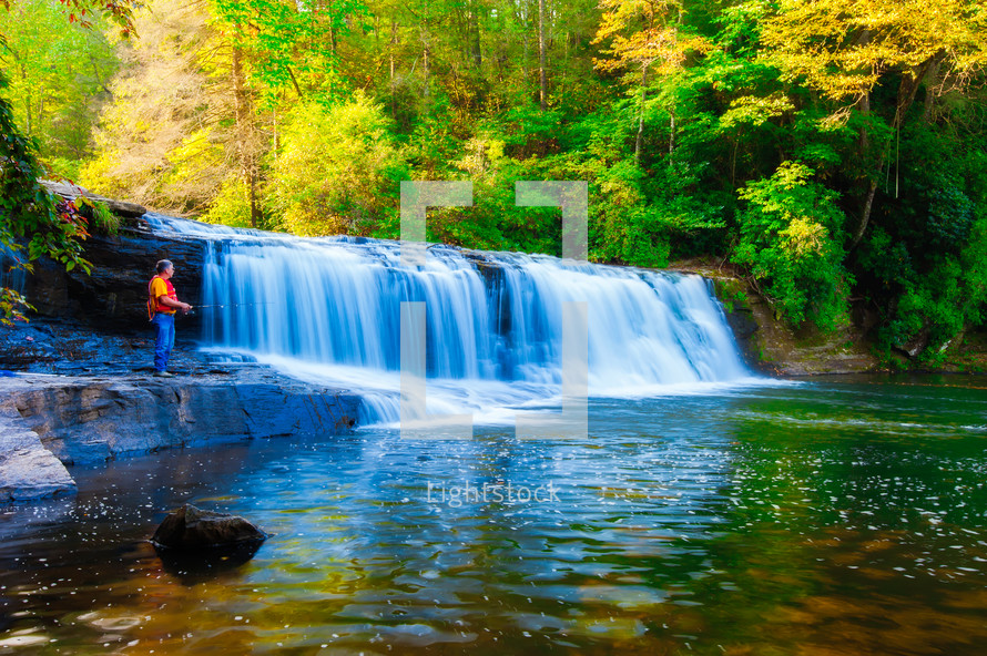 A man trout fishing at Hooker Falls in the Dupont State Forest, North Carolina. 