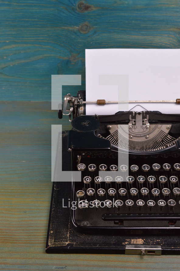 vintage typewriter on teal wooden desk